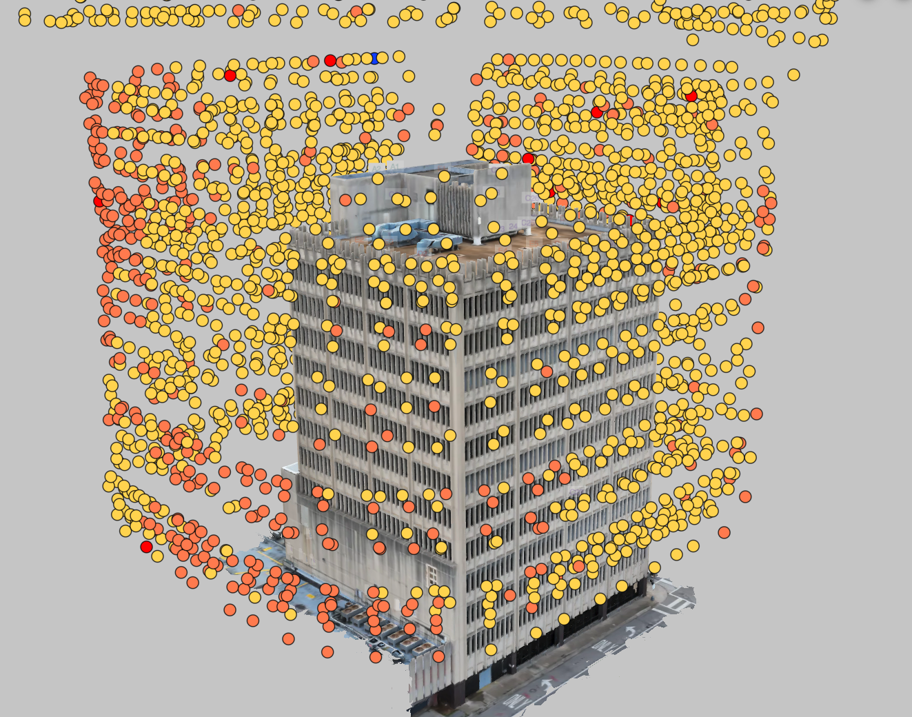 3D building model with colored capture point annotations showing spatial data coverage